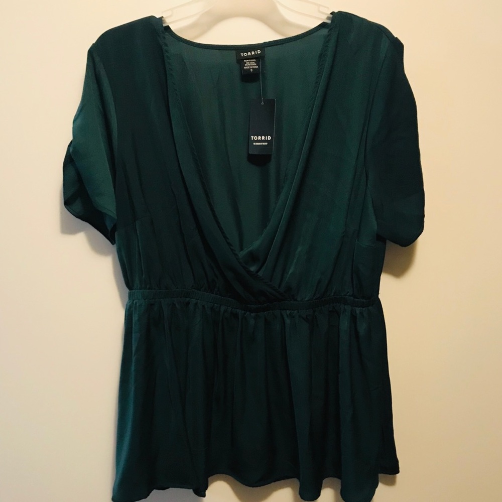 Beautiful peplum top in jewel tone green, with tag